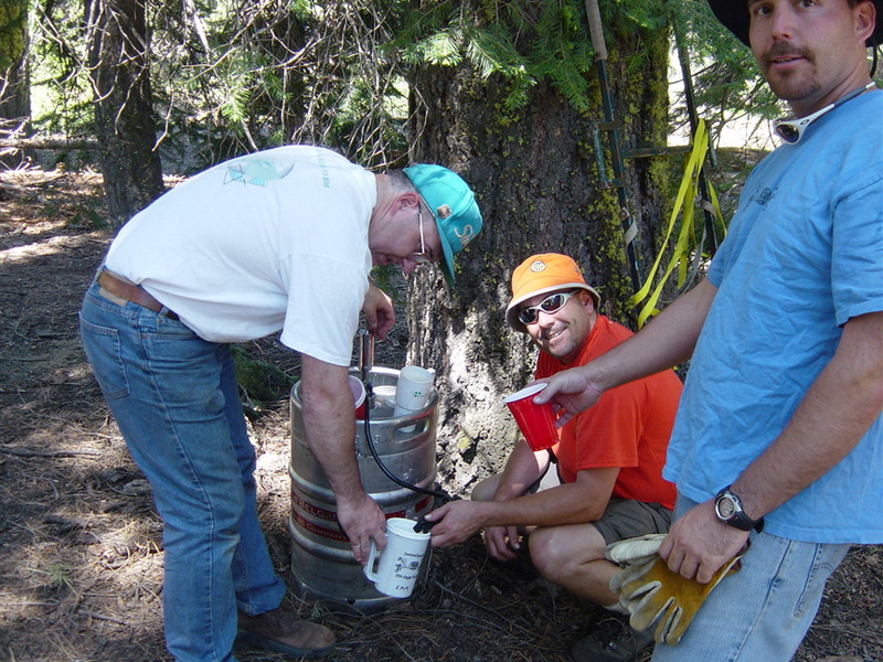 Two men tapping the keg at the 2006 Kegger Backpack